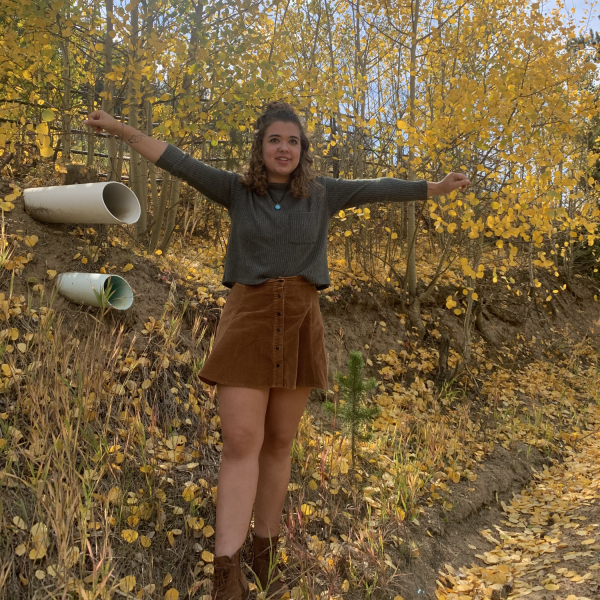Samantha Piel stands in front of trees.