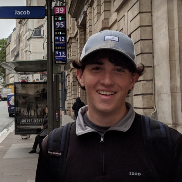 Jakob Rheins stands on a sidewalk.