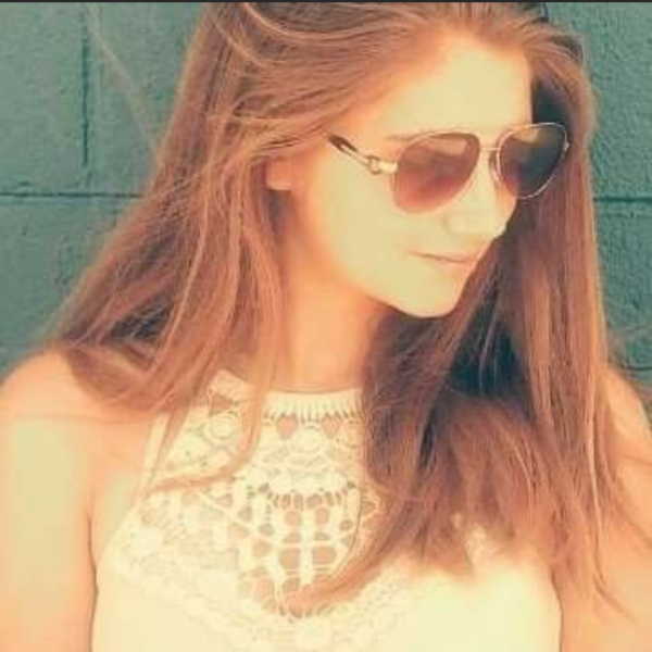 Marissa Ritter stands in front of a wall.
