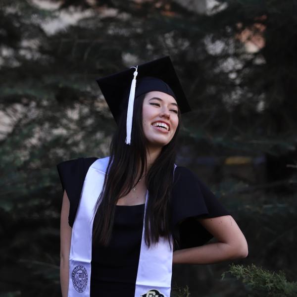 Caitlin Ryan stands in front of trees.