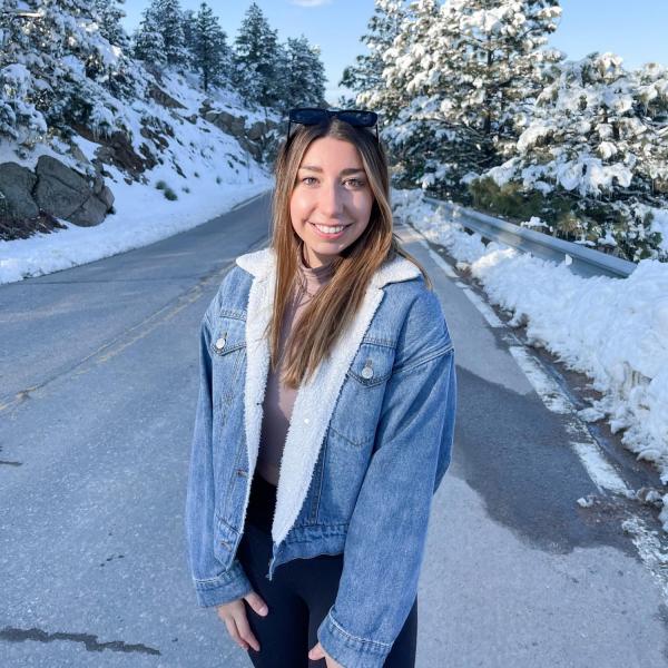 Gracie Sapp stands in front of a road.