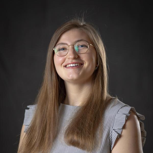 Jenna Solomon stands in front of a wall.