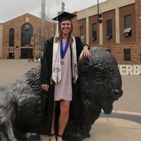 Sophia Marseilles standing in front of Ralphie the Buffalo in front of CU stadium