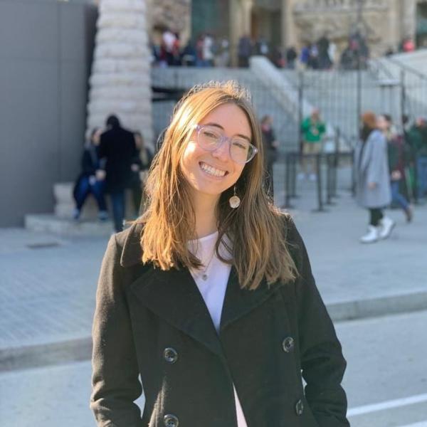 Sabrina Stern stands in front of a building.
