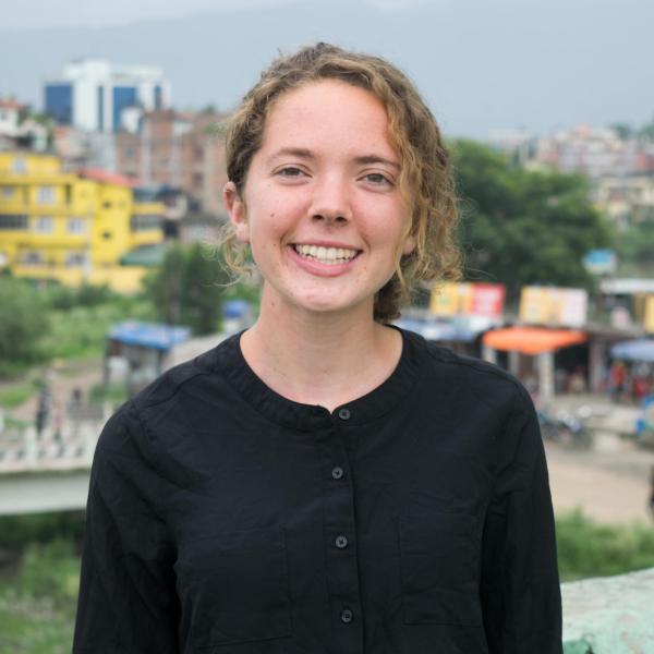 Abigail Weeks stands in front of buildings.