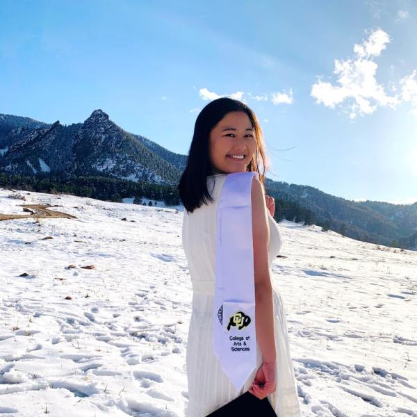 Julie Wolin stands in snow in front of a mountain.