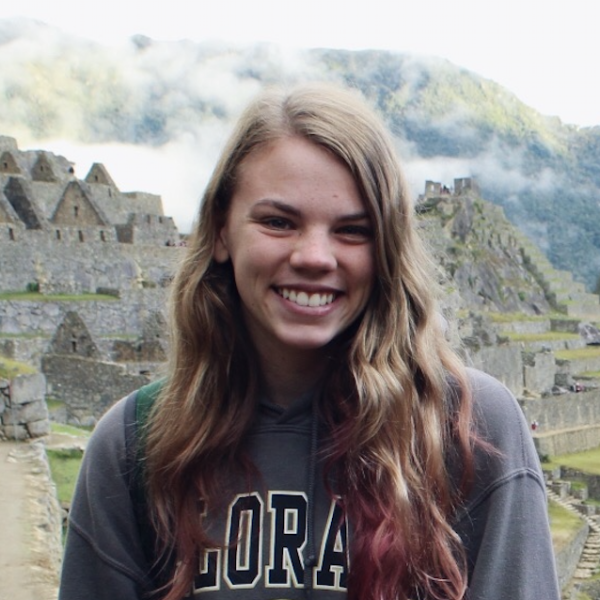 Hayley Wuestenberg stands in front of buildings.