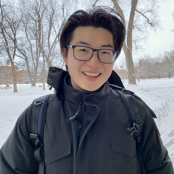 Zhiyu Yao stands in front of trees.