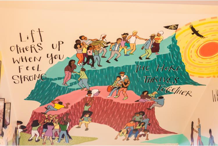 Mural showing students lifting up and supporting each other