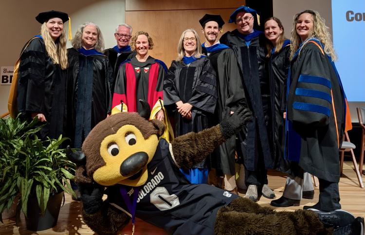 A&S Honors faculty in their regalia posing with Chip the Buffalo mascot