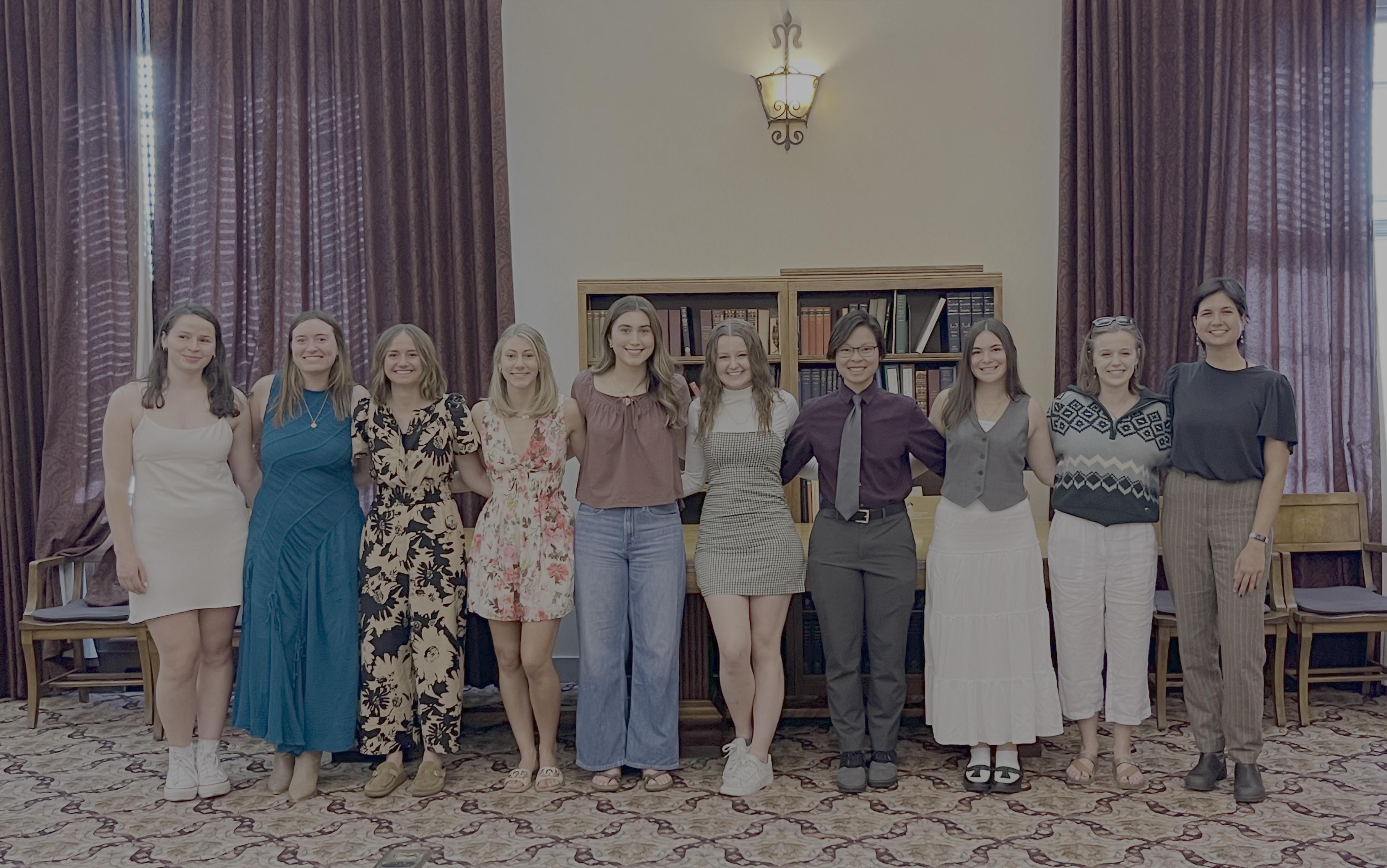 10 students pose together for a photo