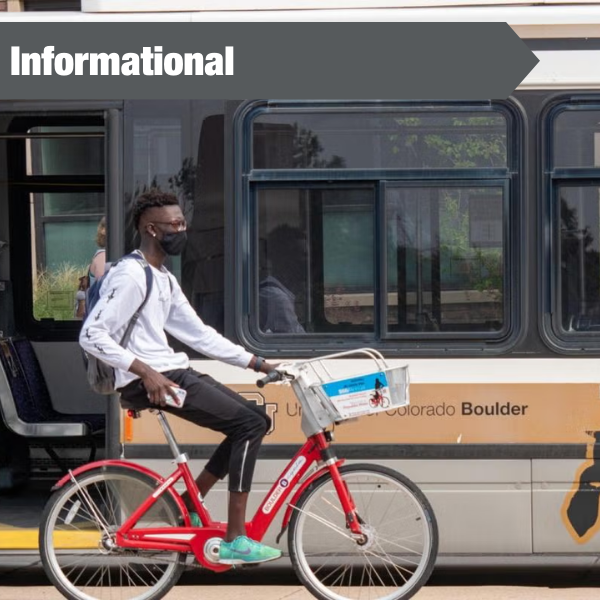 photo of cyclist next to CU Buffs bus