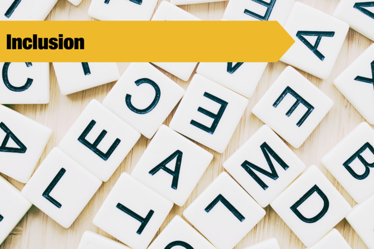 letter tiles with inclusion banner