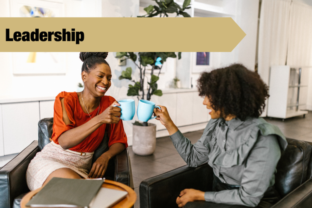 2 people talking with leadership banner