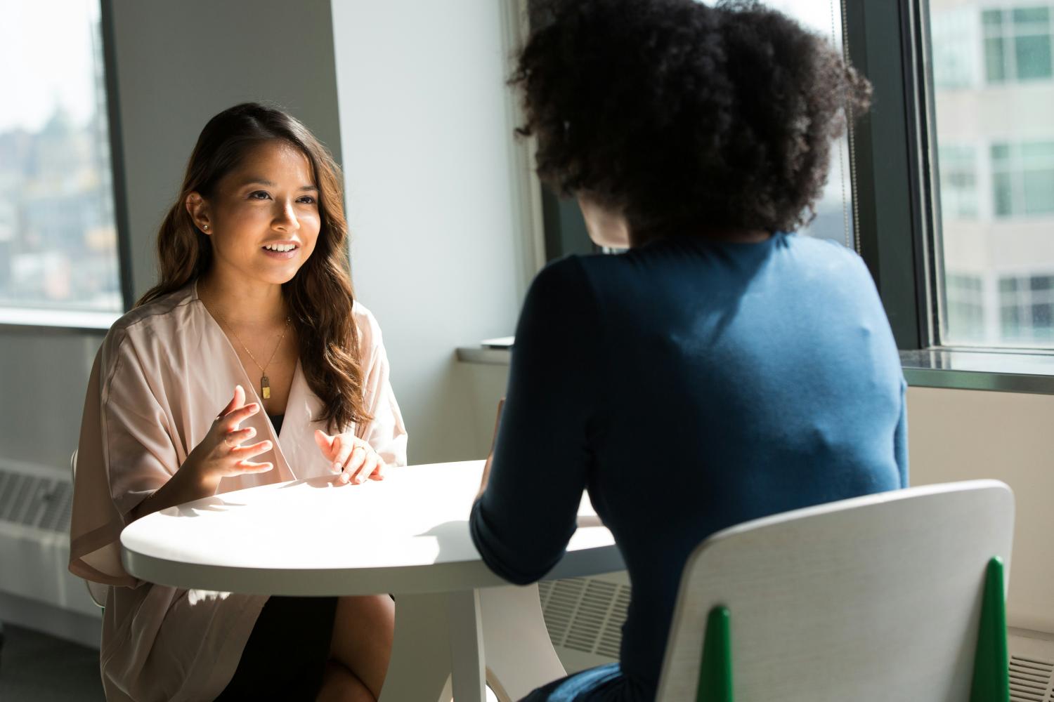 two people talking at a table