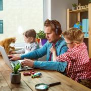 Parent working from home with kids and pets in picture