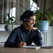 smiling girl looking at laptop