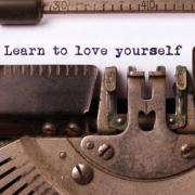 Typewritten "learn to love yourself"