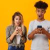 Two people looking at cell phones