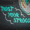Graffiti that says "Trust Your Struggle" 