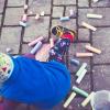 Child coloring with chalk
