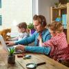 Parent working from home with kids and pets in picture