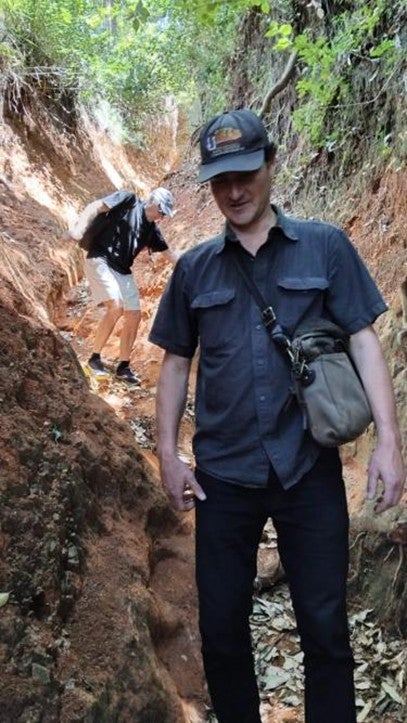 John O’Loughlin and Andrew Linke—a former CU Boulder Geography PhD student and TA—navigate a narrow, slippery ravine while traveling to meet a village elder in Machakos County, Kenya (February 2025).