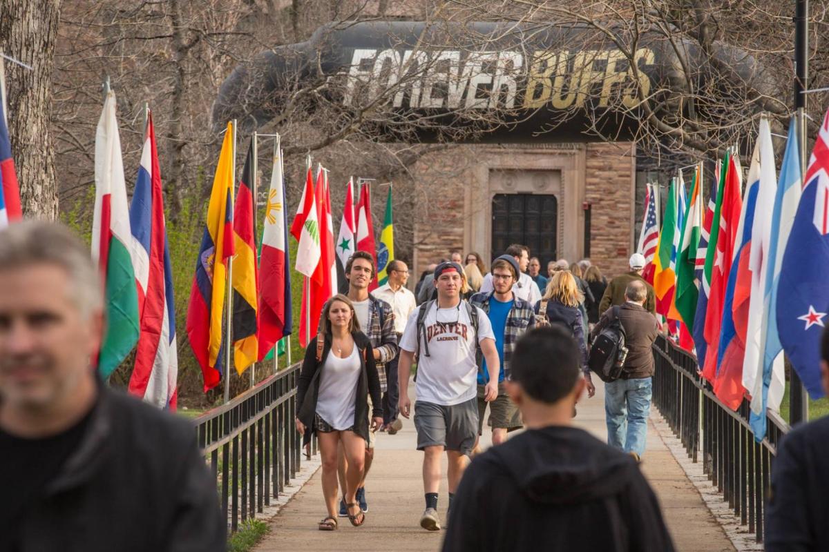 students walking on campus with flags
