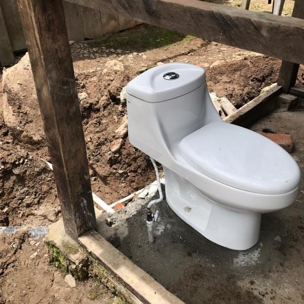 toilet installed in outdoor bathroom