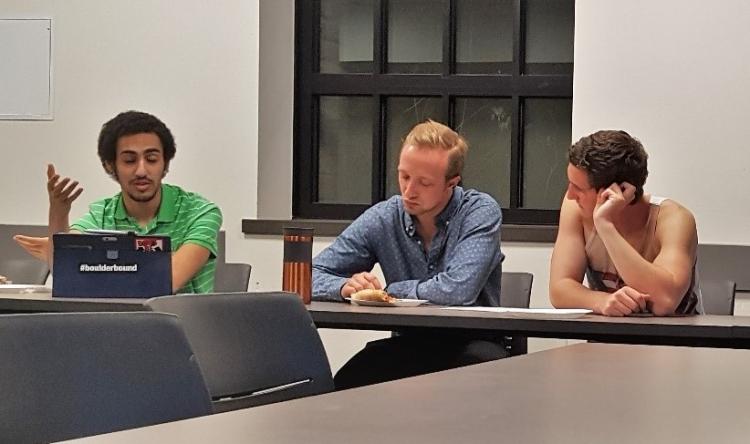 three male students talking