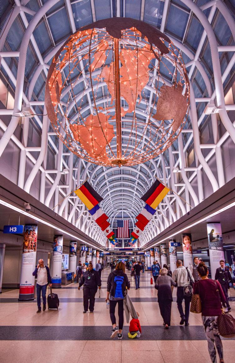 airport terminal with suspended globe and flags