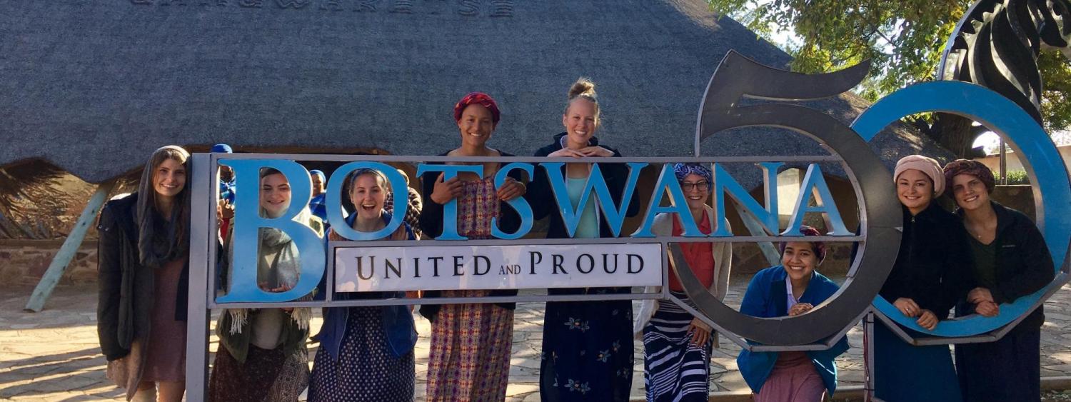 maja and group of students near botswana sign