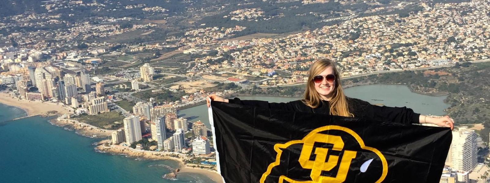 grace standing with cu colorado flag in europe