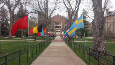 cu boulder campus sidewalk with a variety of national flags