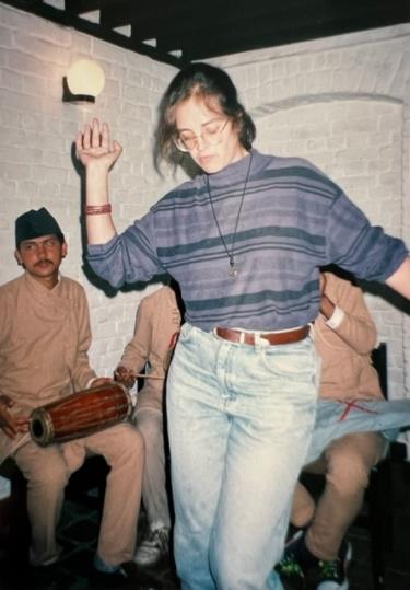 young american woman dancing while in Nepal in the 1990s