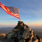 American flag on top of mountain