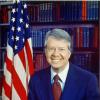 photo of former US president Jimmy Carter in 1977 with an American flag in the background. 