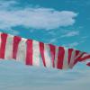 red-and-white-striped-flag-under-blue-sky-during-daytime