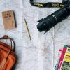 map with a camera, guide books, pencil, satchel.
