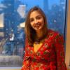 photo of erin neale wearing red dress in windowsill