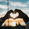 person holding heart shape with their hands