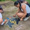 photo of daisy chalk painting a CU Buffs logo