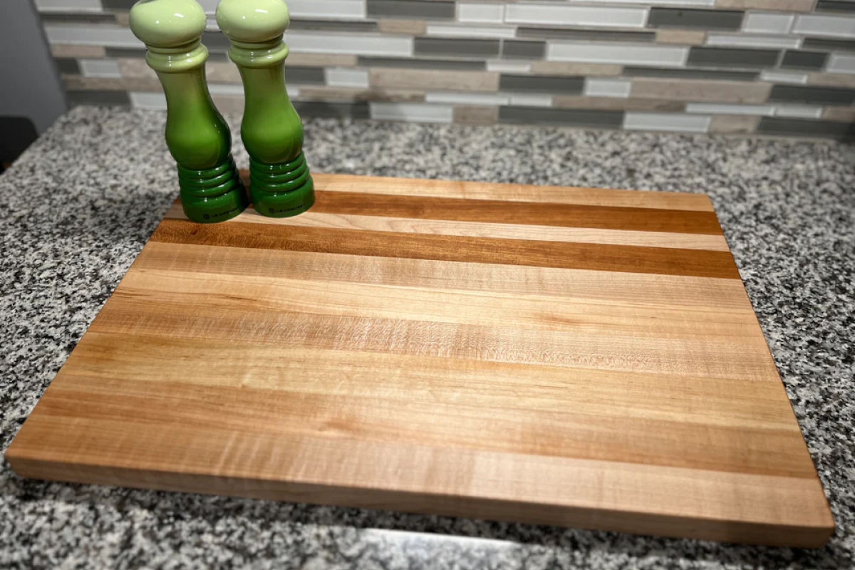 Charcuterie board displayed on countertop with salt and pepper shakers next to it