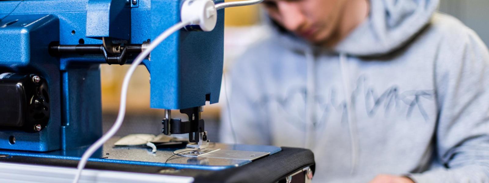 student using industrial sewing machine