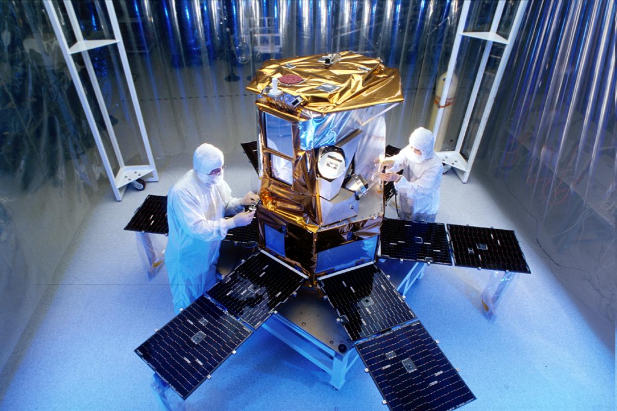 working on satellite in clean room