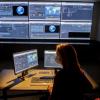 Woman watching multiple monitors