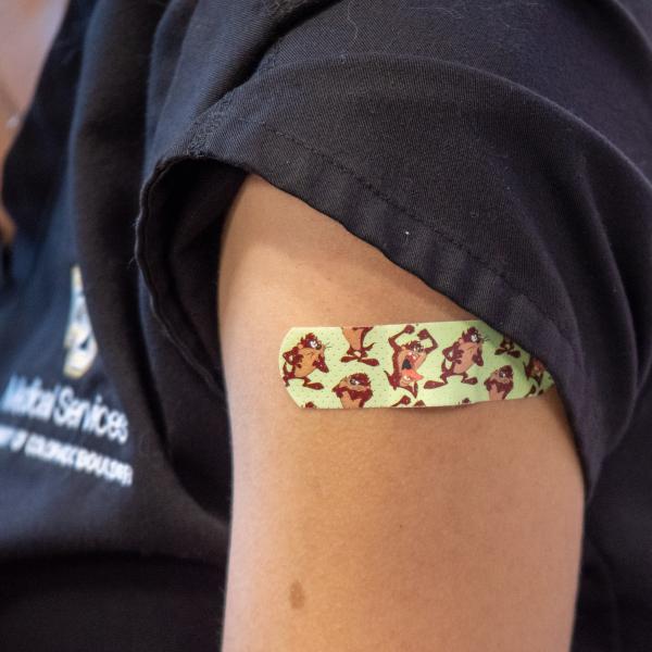 Person's arm with a band aid
