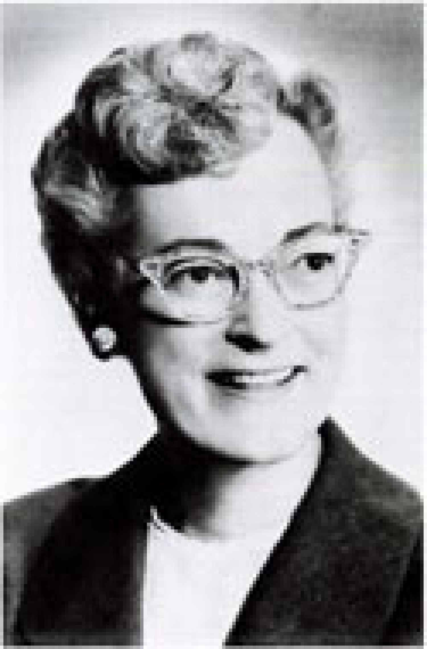 A black and white photo of Ruth Abernathy wearing glasses and smiling