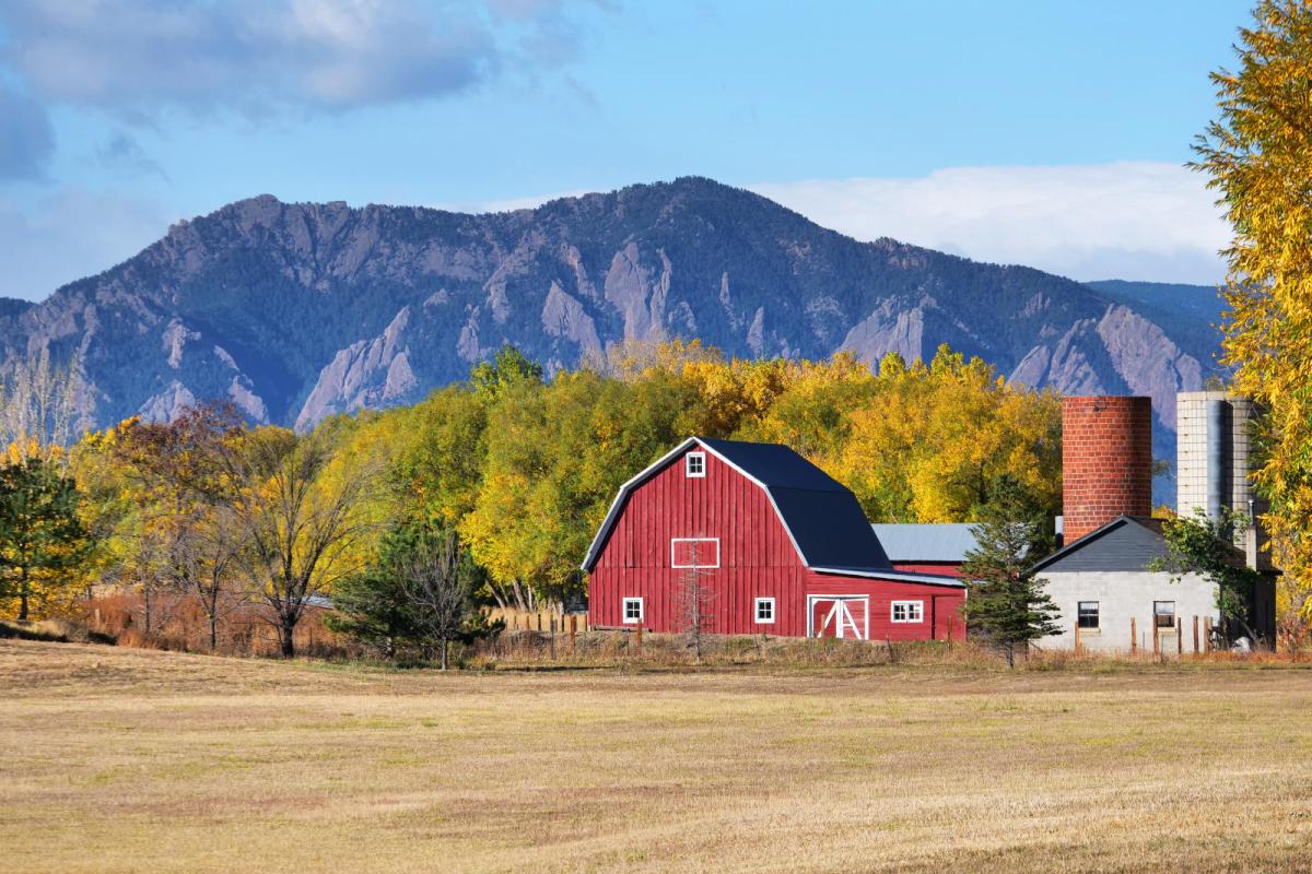 a large red barn and silo on a farm east of Boulder