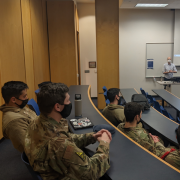Professor talks with US Air Force Academy personnel in classroom